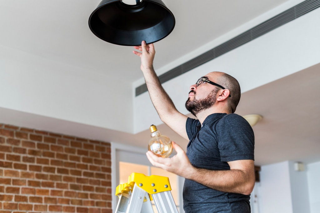 man installing lamp in home